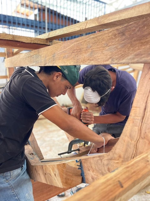 Student with the boat he built